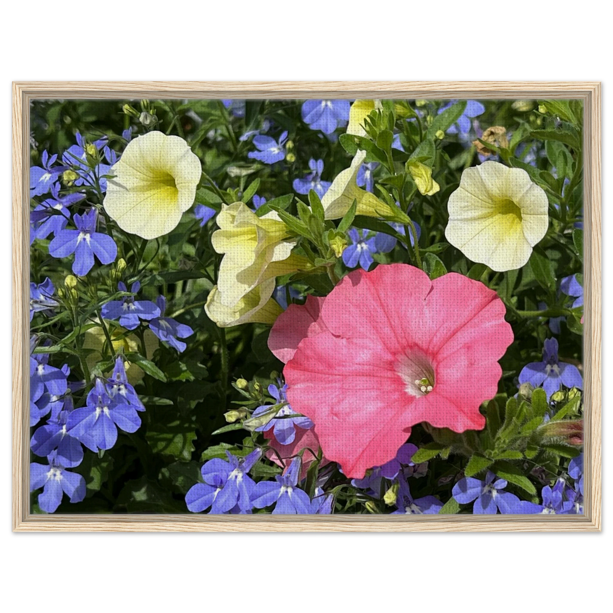 Yellow, blue, and pink floral wall art in light wood frame