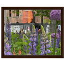 Framed canvas art with purple lupine and allium flowers, displayed in a dark wood frame