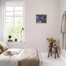 Violet daisy framed artwork displayed on a light bedroom wall beside a window