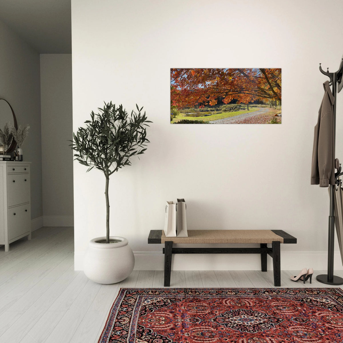 Entryway decorated with vibrant autumn foliage canvas above a bench