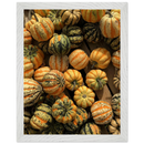 Framed vertical print with green and orange gourds closely packed together