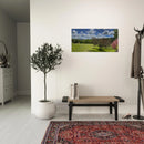 Entryway with spring landscape canvas artwork above a bench and patterned rug, creating a welcoming atmosphere