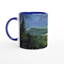 Ceramic mug with mountain lake design and deep blue interior