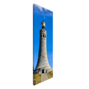 Side perspective of stone tower canvas art with a clear blue background