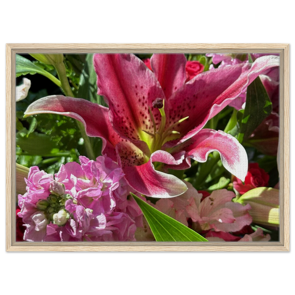 Pink lily floral wall art in a light natural wood frame