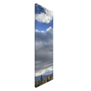 Vertical edge view of cloud-filled sky over serene mountains