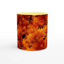 Front view of mug with yellow interior and vibrant orange chrysanthemum design