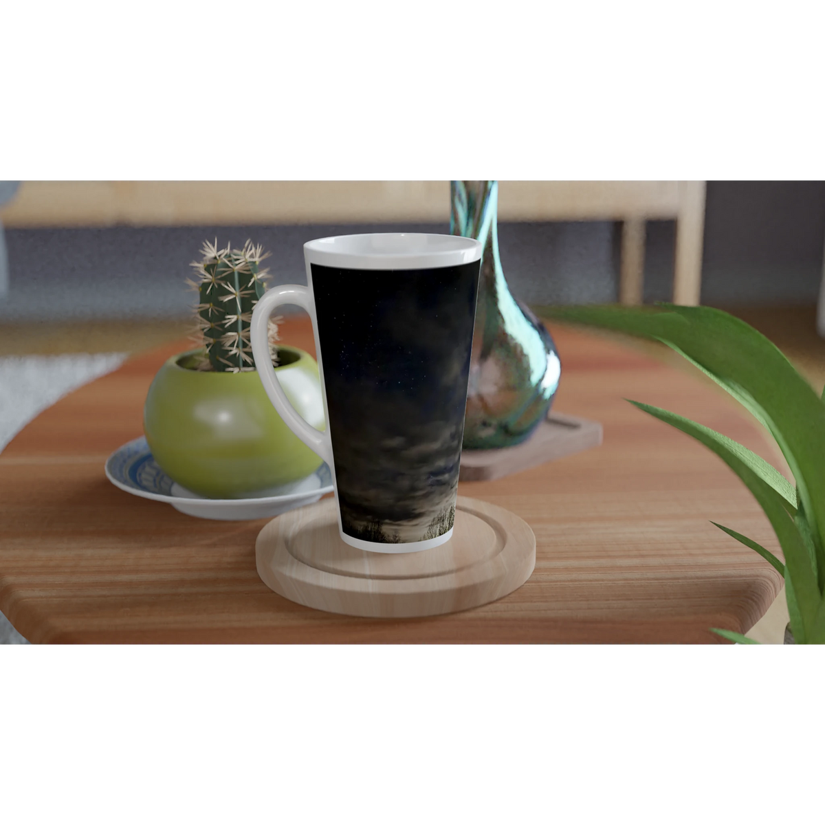 Night sky ceramic latte mug displayed on a wooden table with plants