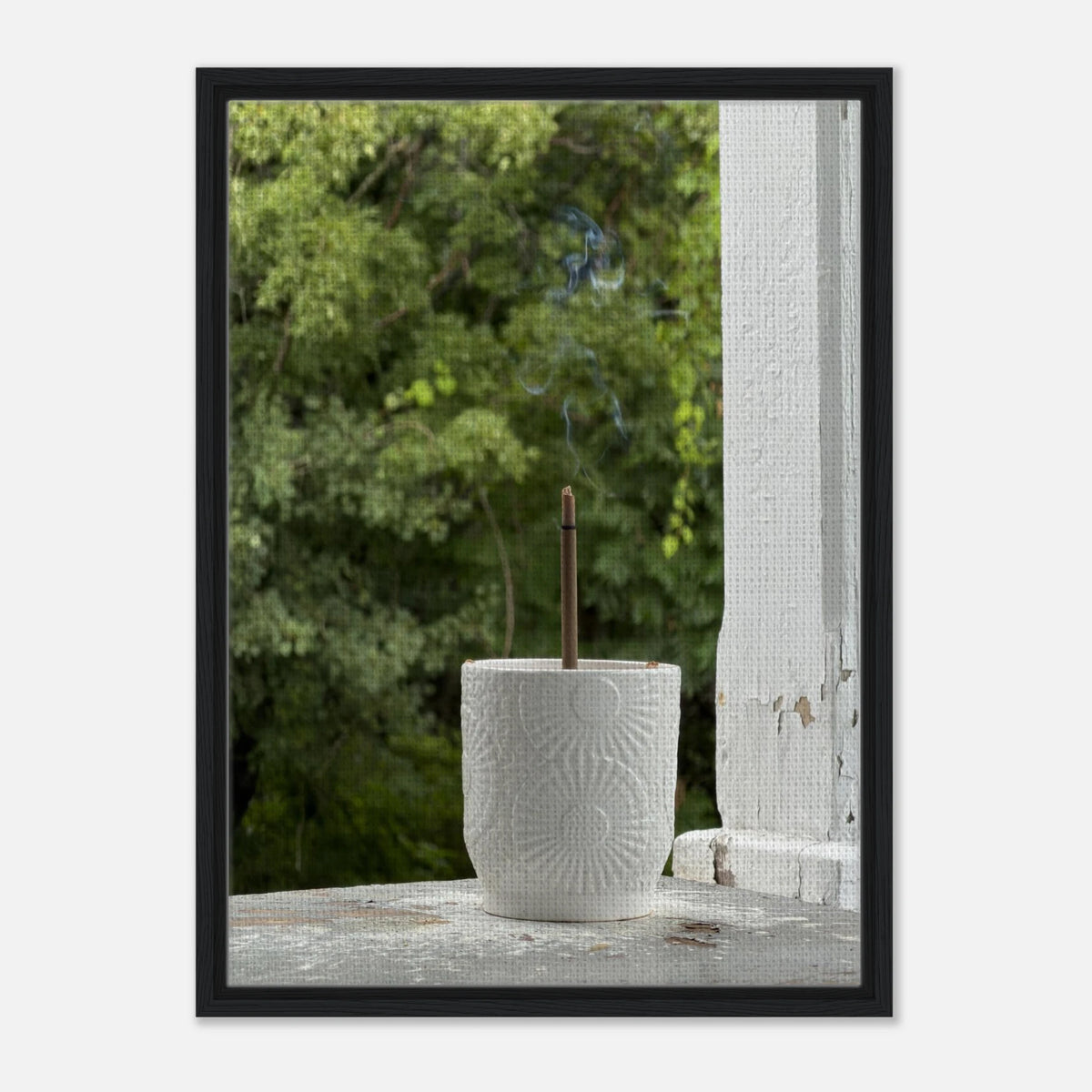 Black thin frame canvas print of incense holder outdoors with vibrant green background