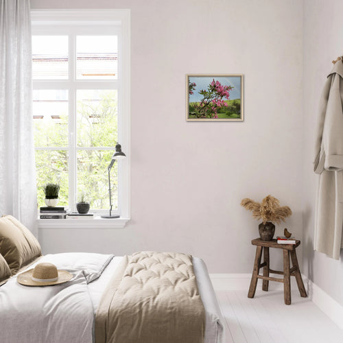 Cozy minimalist bedroom with framed pink azalea and rainbow canvas on the wall